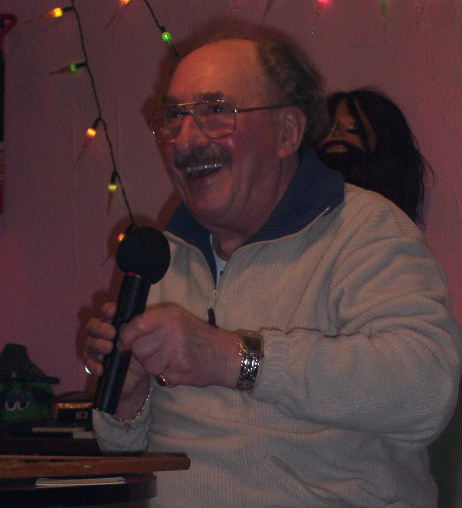 Gordon Cragg seated at bingo table and smiling broadley